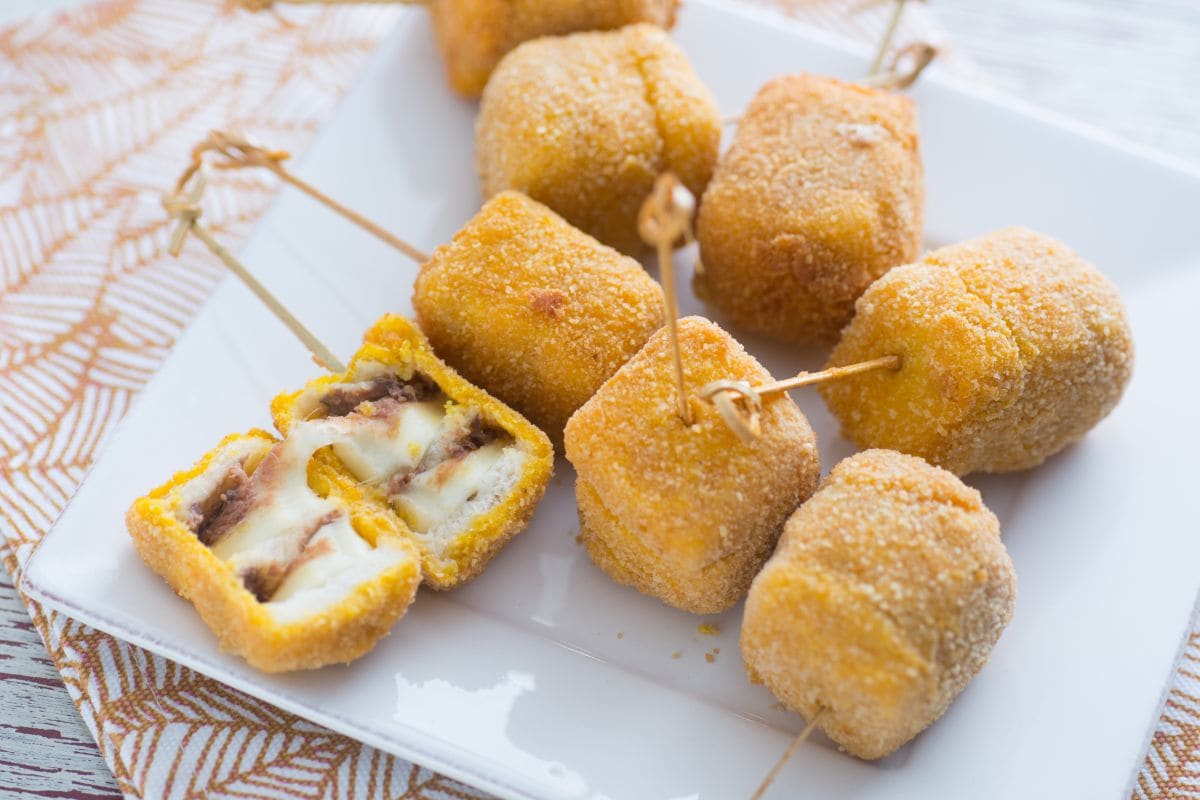 Fried mozzarella and anchovy skewers