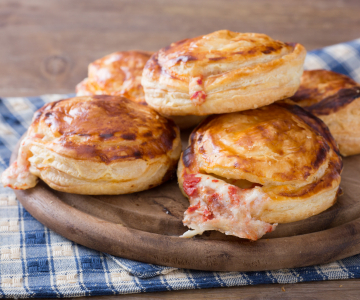 Rustici leccesi (Puff pastry appetizers with béchamel, mozzarella, and tomato)