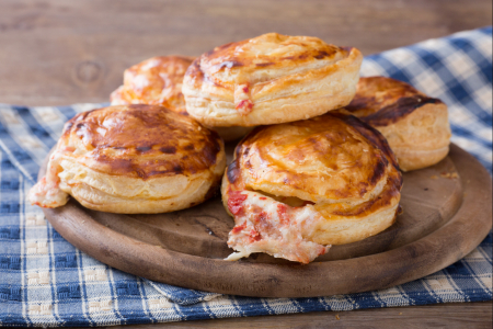 Rustici leccesi (Puff pastry appetizers with béchamel, mozzarella, and tomato)