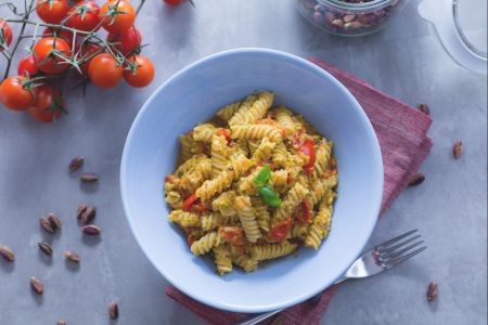 Fusilli pasta with pistachio pesto and cherry tomatoes