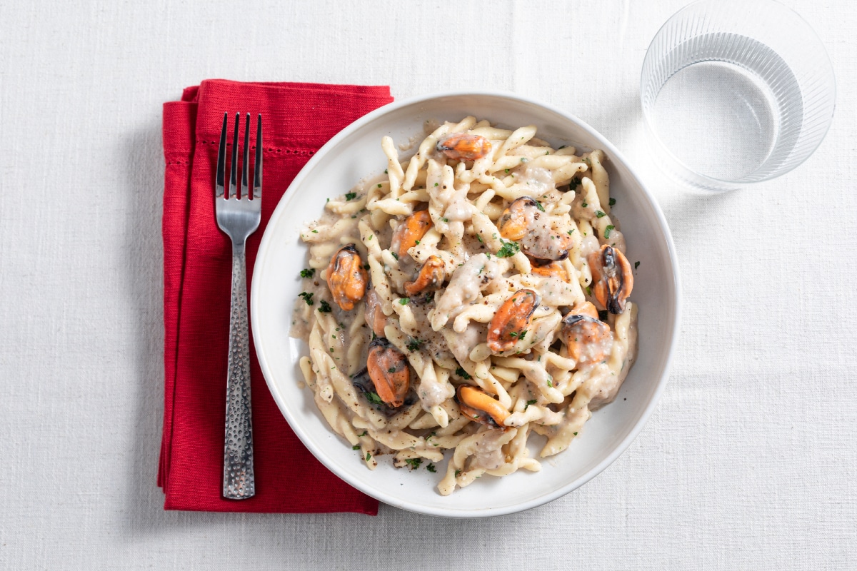 Strozzapreti pasta with cacio cheese, mussels, and pepper