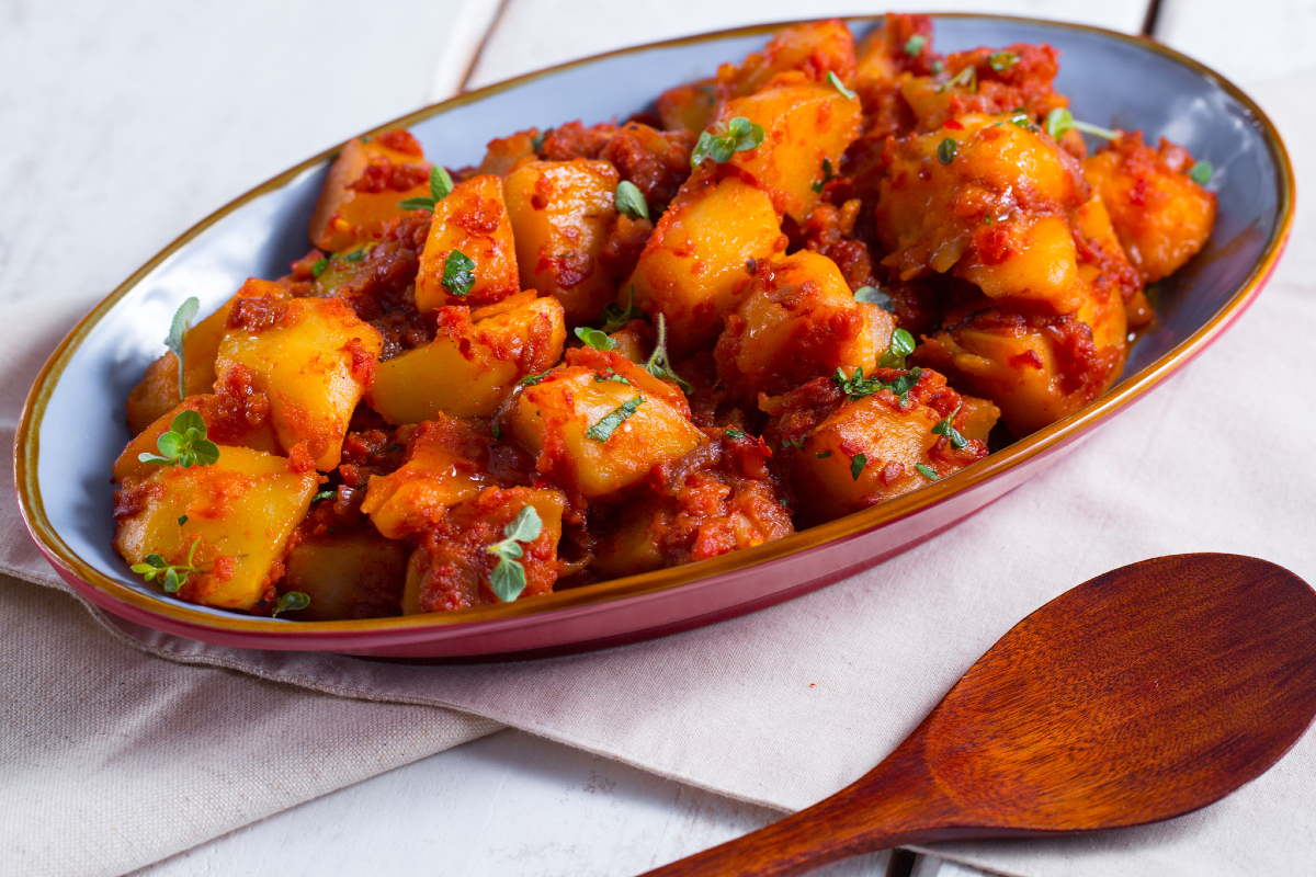 Country-style potatoes with tomato and red onion