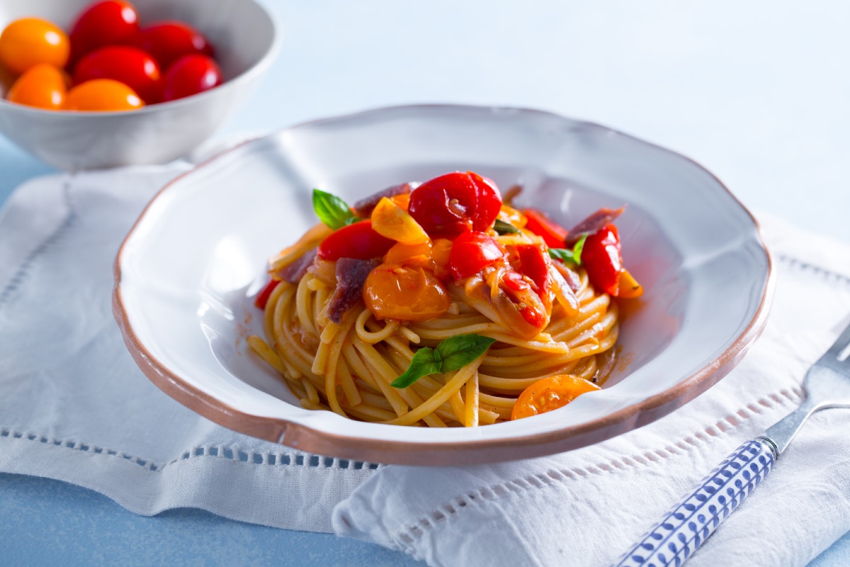 Pasta with cherry tomatoes anchovies and onion