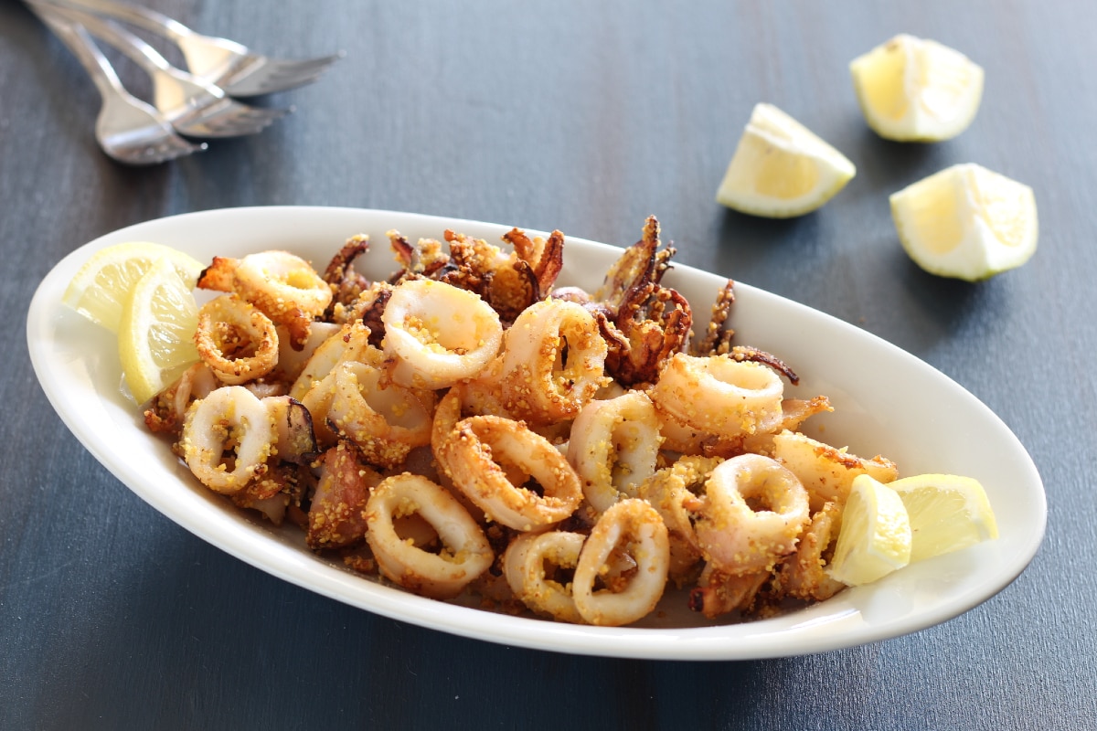 fried squids or octopus (calamari) with sauce Stock Photo | Adobe Stock