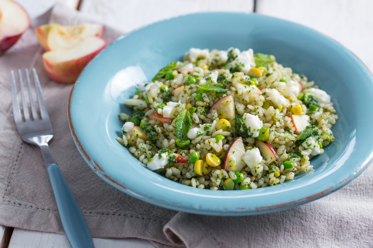Rice salad with peaches, peas and stracchino cheese