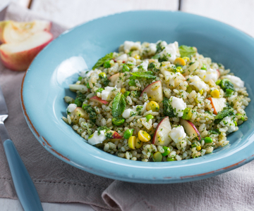 Rice salad with peaches, peas and stracchino cheese