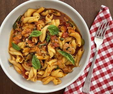 Pasta with canned tuna, olives, capers and tomatoes