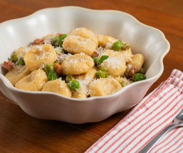 Ricotta gnocchi with peas, pecorino, and guanciale