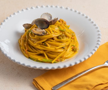 Spaghetti with clams, zucchini flowers, and saffron