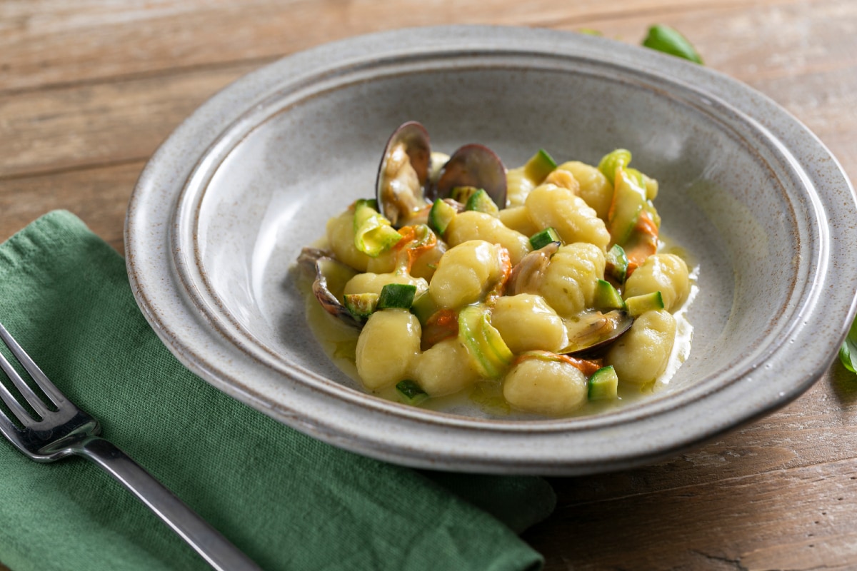 Gnocchi with clams, zucchini and yellow cherry tomatoes