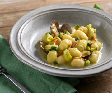 Gnocchi with clams, zucchini and yellow cherry tomatoes