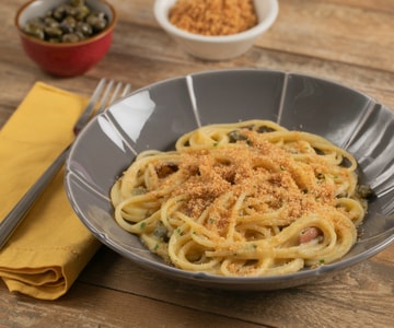 Gluten-free spaghetti with yellow cherry tomato sauce, capers, and anchovies