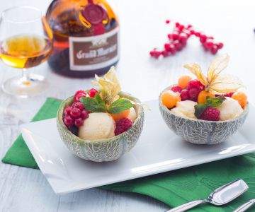 Melon filled with fruit and ice cream