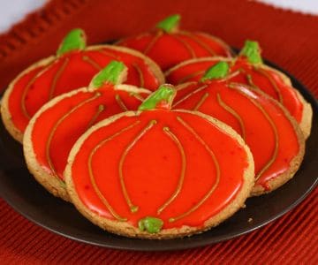 Pumpkin-shaped glazed cookies