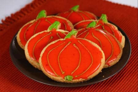 Pumpkin-shaped glazed cookies