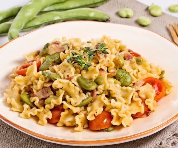 Pasta with fava beans, bacon, and cherry tomatoes