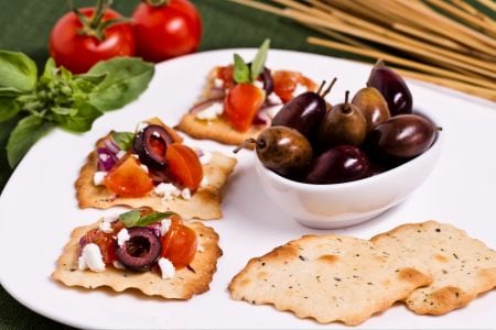 Olive puffs with tomato and feta crumbs