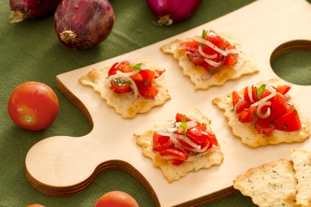 Puff pastries with olives, onions, and cherry tomatoes