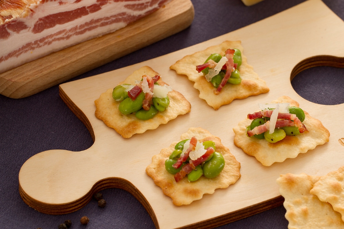 Classic puff pastries with broad beans, bacon, and pecorino
