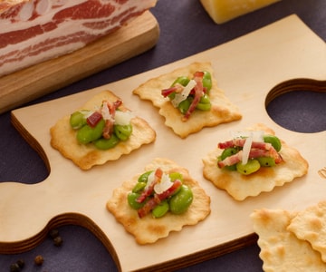 Classic puff pastries with broad beans, bacon, and pecorino