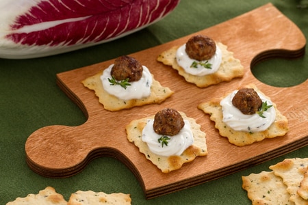 Puff pastries with olives and radicchio meatballs with yogurt cream