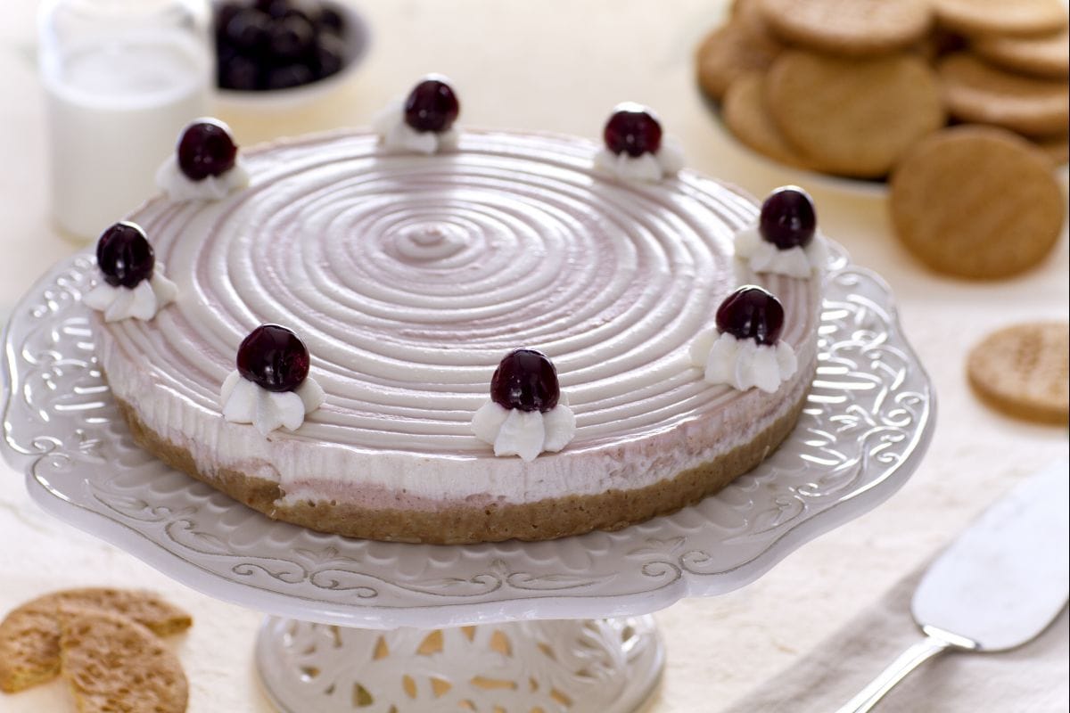 Two-tone cheesecake with cream and black cherries