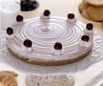 Two-tone cheesecake with cream and black cherries