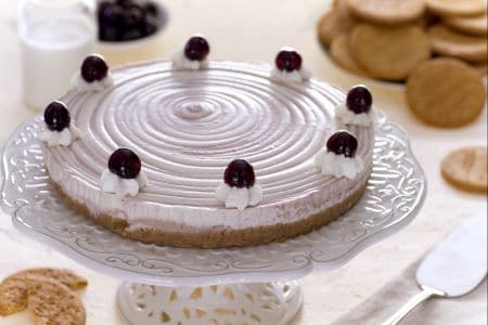 Two-tone cheesecake with cream and black cherries