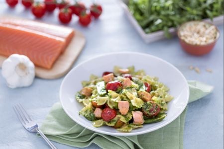 Farfalle with salmon, snow peas, and confit cherry tomatoes with arugula pesto