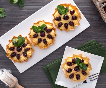 Mini tarts filled with custard and sour cherries