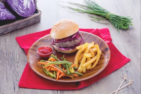 Herb-flavored hamburger with mixed vegetables and fries