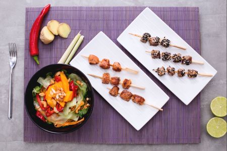Tuna and salmon skewers with Thai salad