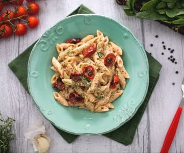 Whole wheat mezze penne rigate with roasted tomato pesto, ricotta, and spinach powder