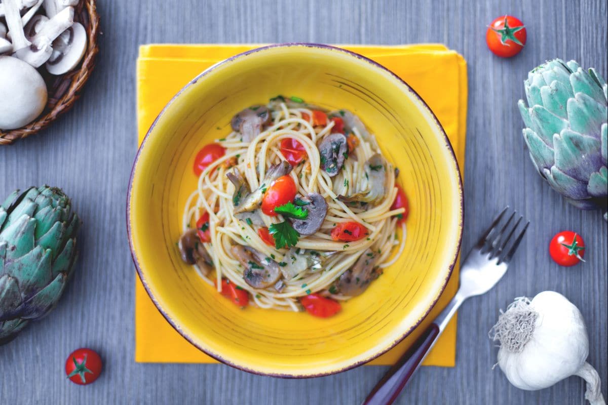 Spaghetti with mushrooms, artichokes, and cherry tomatoes