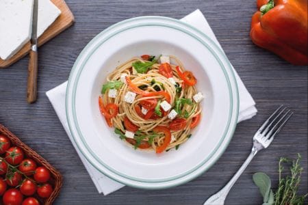Whole wheat spaghetti with red peppers, arugula, and feta