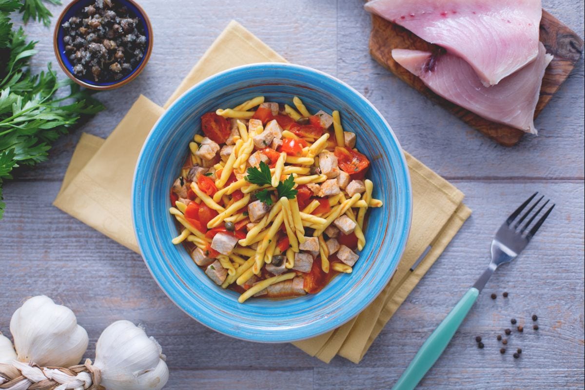 Strozzapreti with swordfish, cherry tomatoes, and capers