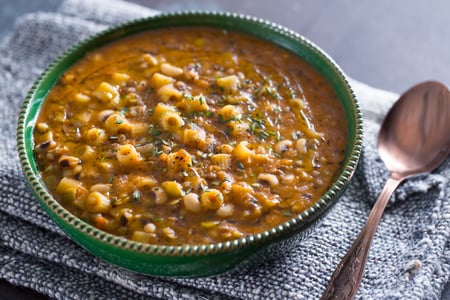 Pasta soup with mixed legumes and bay leaf