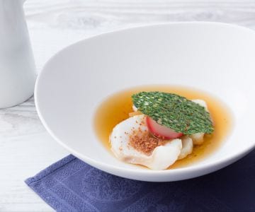 Ham broth, flaky cod with crispy bread and radishes