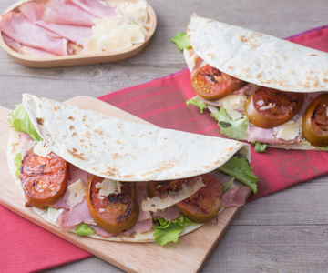 Flatbread with ham, pecorino cheese, and tomatoes