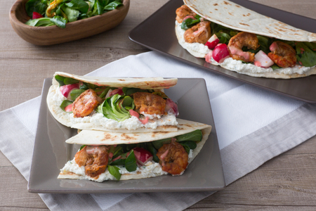 Flatbread with shrimp, zucchini flowers, and salad