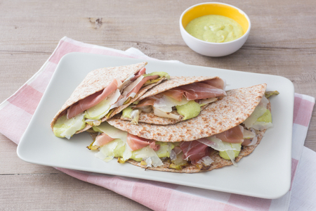 Flatbread with prosciutto, fava bean pesto, and endive