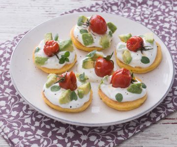 Corn blinis with skyr, avocado, and roasted cherry tomatoes