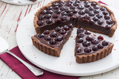 Hazelnut tart with dark chocolate ganache and sour cherries
