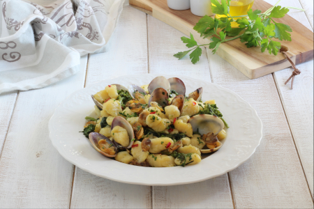 Gnocchi with clams and turnip tops