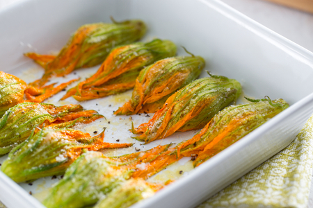 Baked zucchini flowers with anchovies and Grana Padano