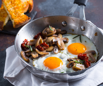 Fried eggs with mushrooms and sun-dried tomatoes