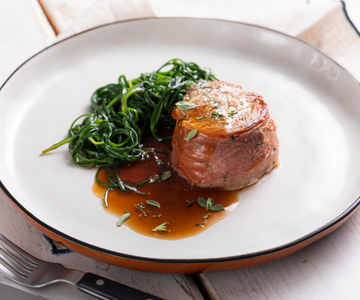 Pork tenderloin wrapped with agretti