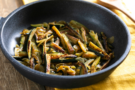 Tasty pan-fried zucchini with onion