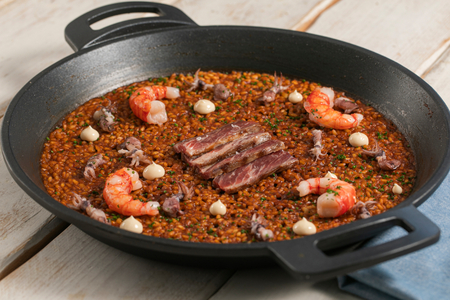 Paella with shrimp, squid, and Iberian presa