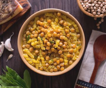 Pasta in chickpea soup with bay leaf and red garlic